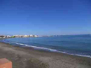 Sunny Christmas day on the paseo mar�timo in Benalmadena, people walking by the sea.